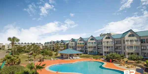 Image 2: Community pool featuring a patio area and a residential view