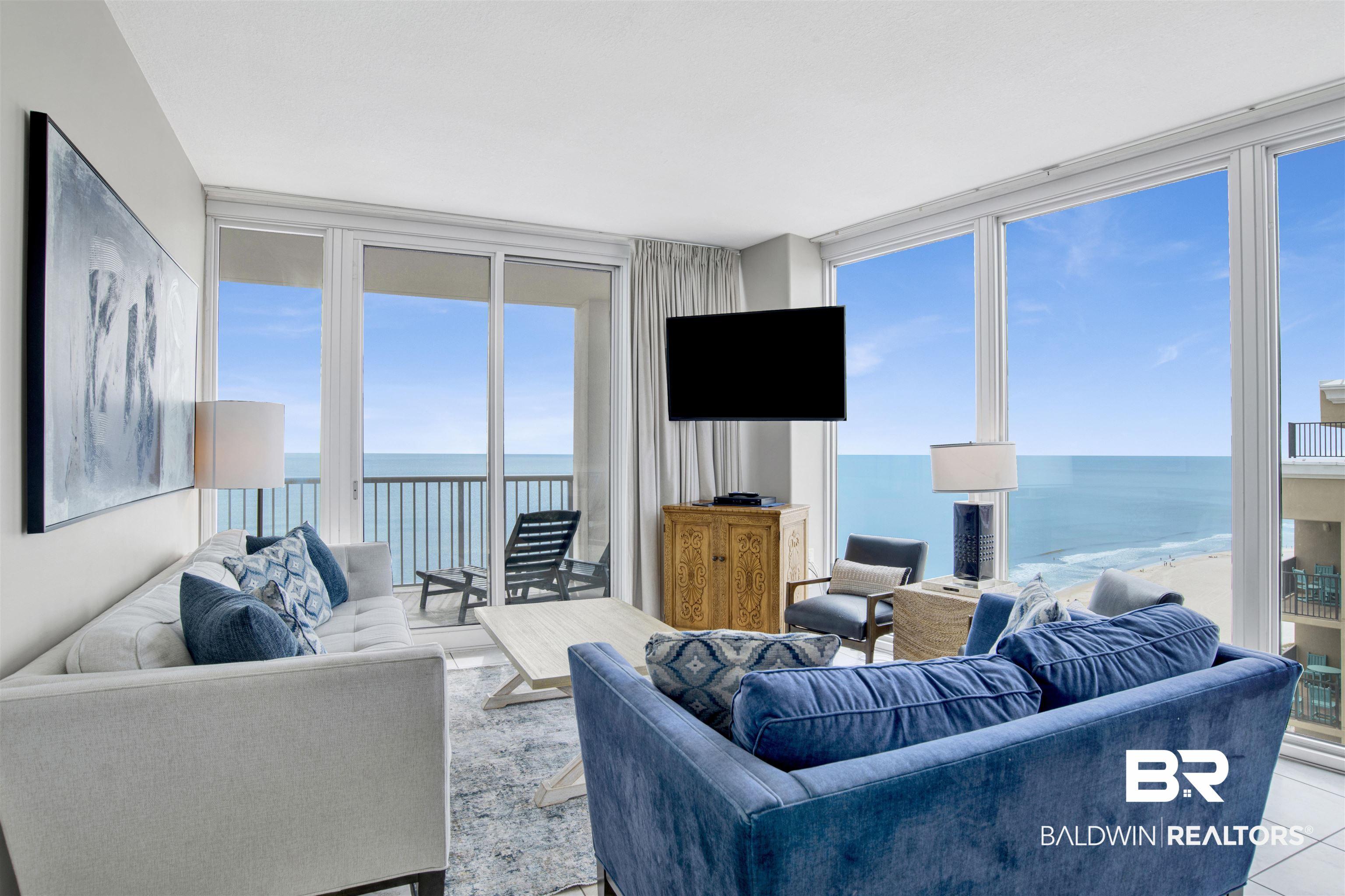 Image 3: Living room with floor to ceiling windows and tile patterned floors