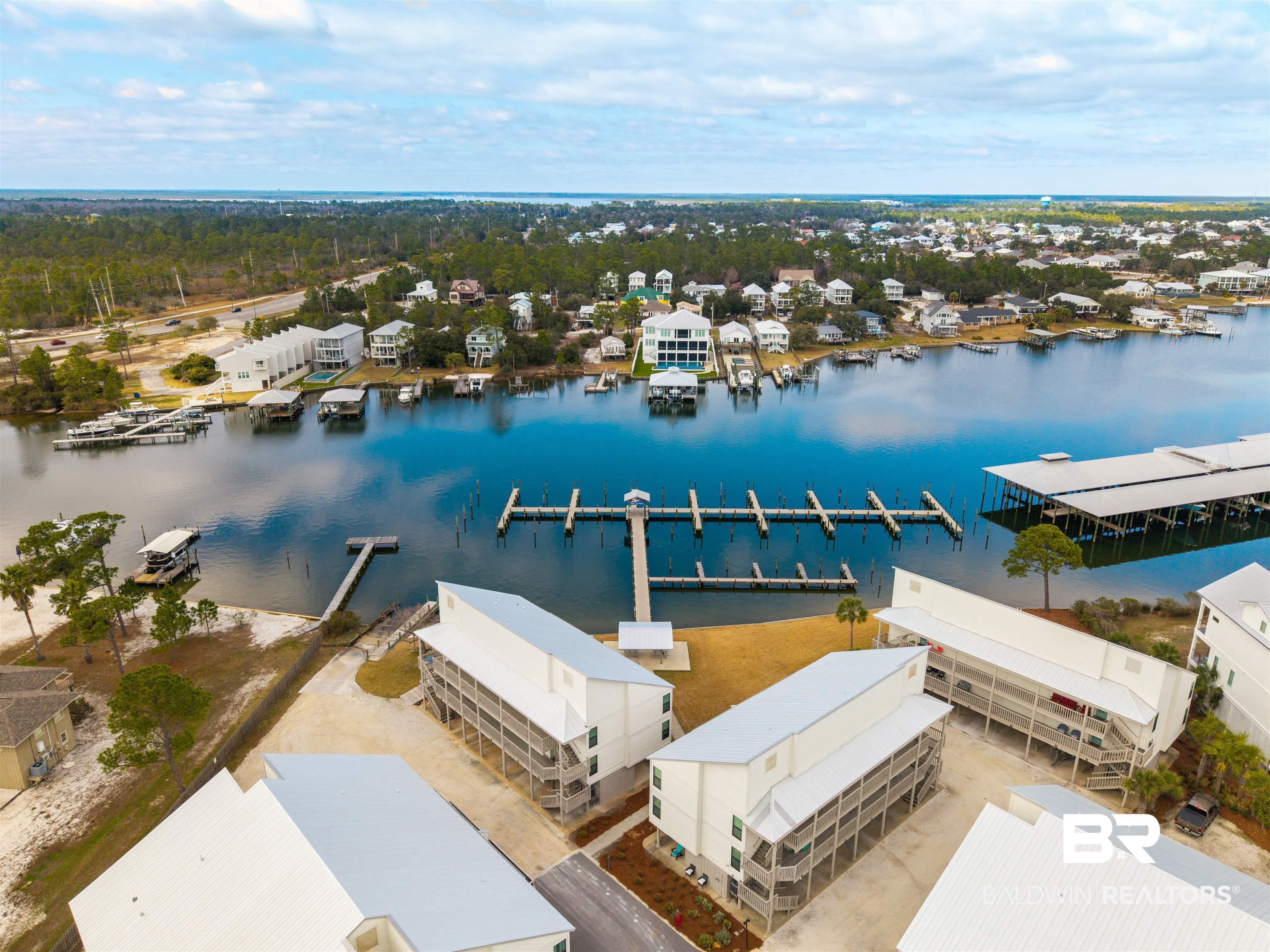 Image 4: Aerial view of residential area with a nearby body of water