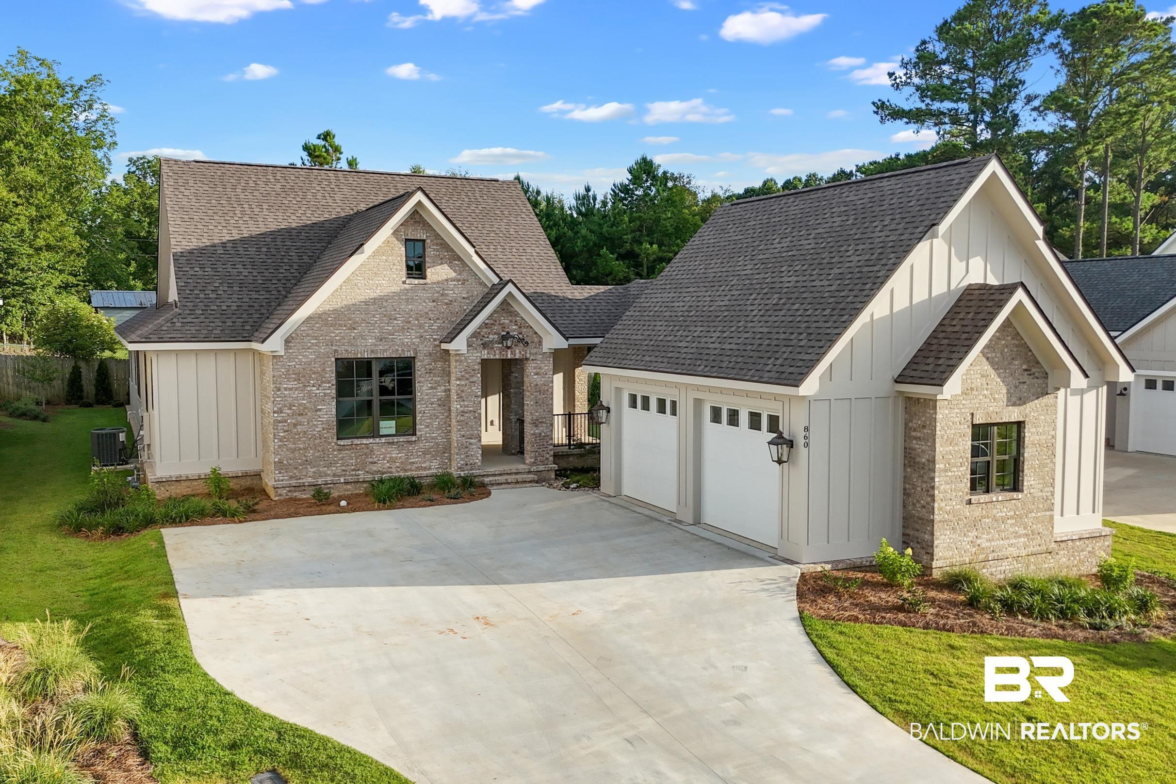 Image 2: Contemporary architectural design featuring a blend of light-toned brick and vertical board-and-batten siding