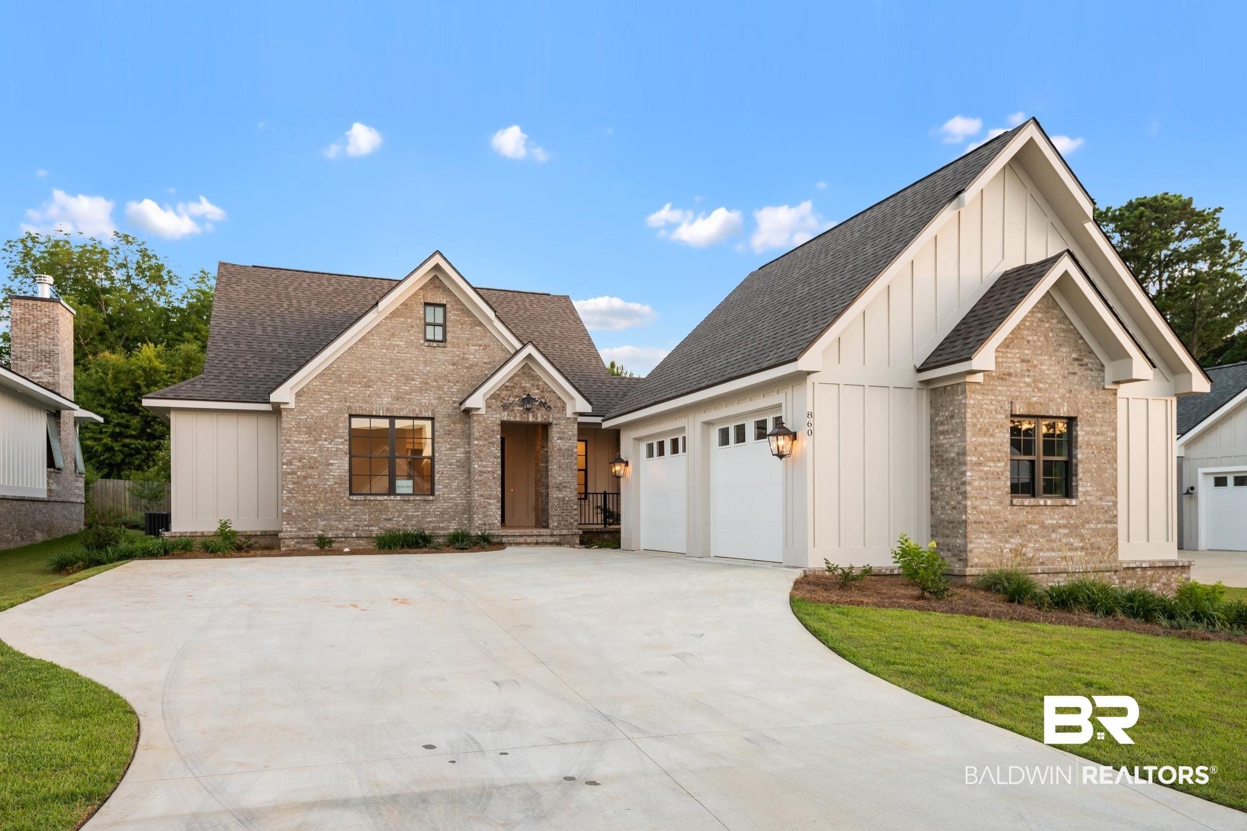 Image 3: Contemporary home featuring a light brick facade, white vertical siding, dark shingle roofing, and a concrete driveway
