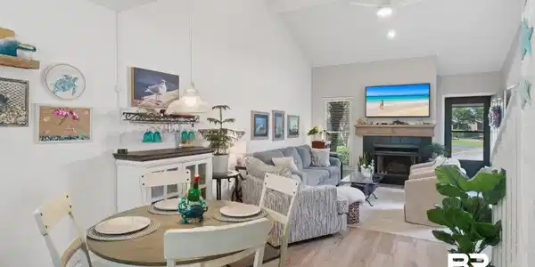 Image 3: Bright and open with LVP floors, vaulted ceilings and a fireplace.