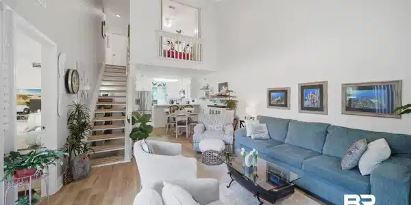 Image 4: Primary suite located on first floor with patio access and en-suite bath.