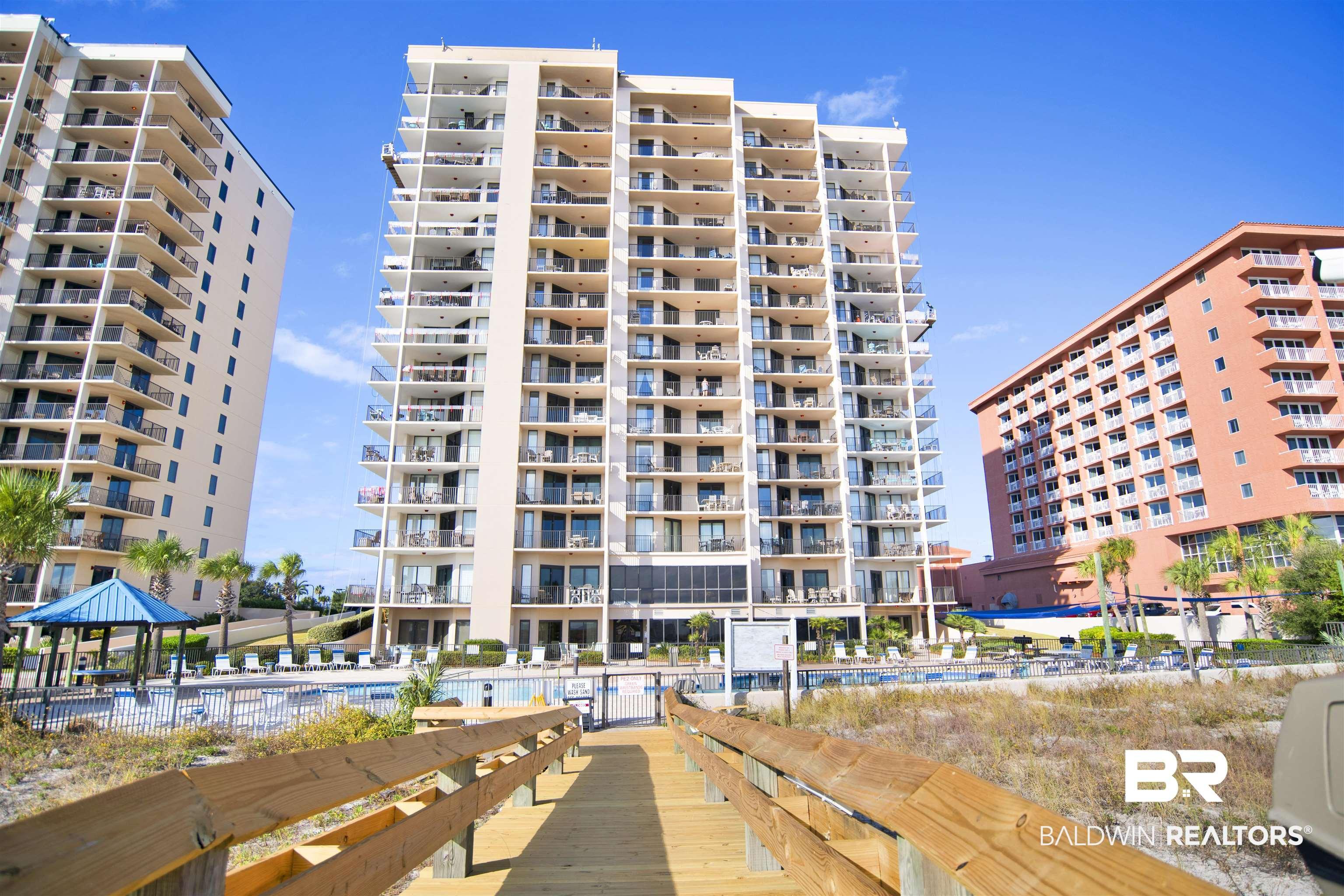 Image 1: View of apartment building / complex with a community pool
