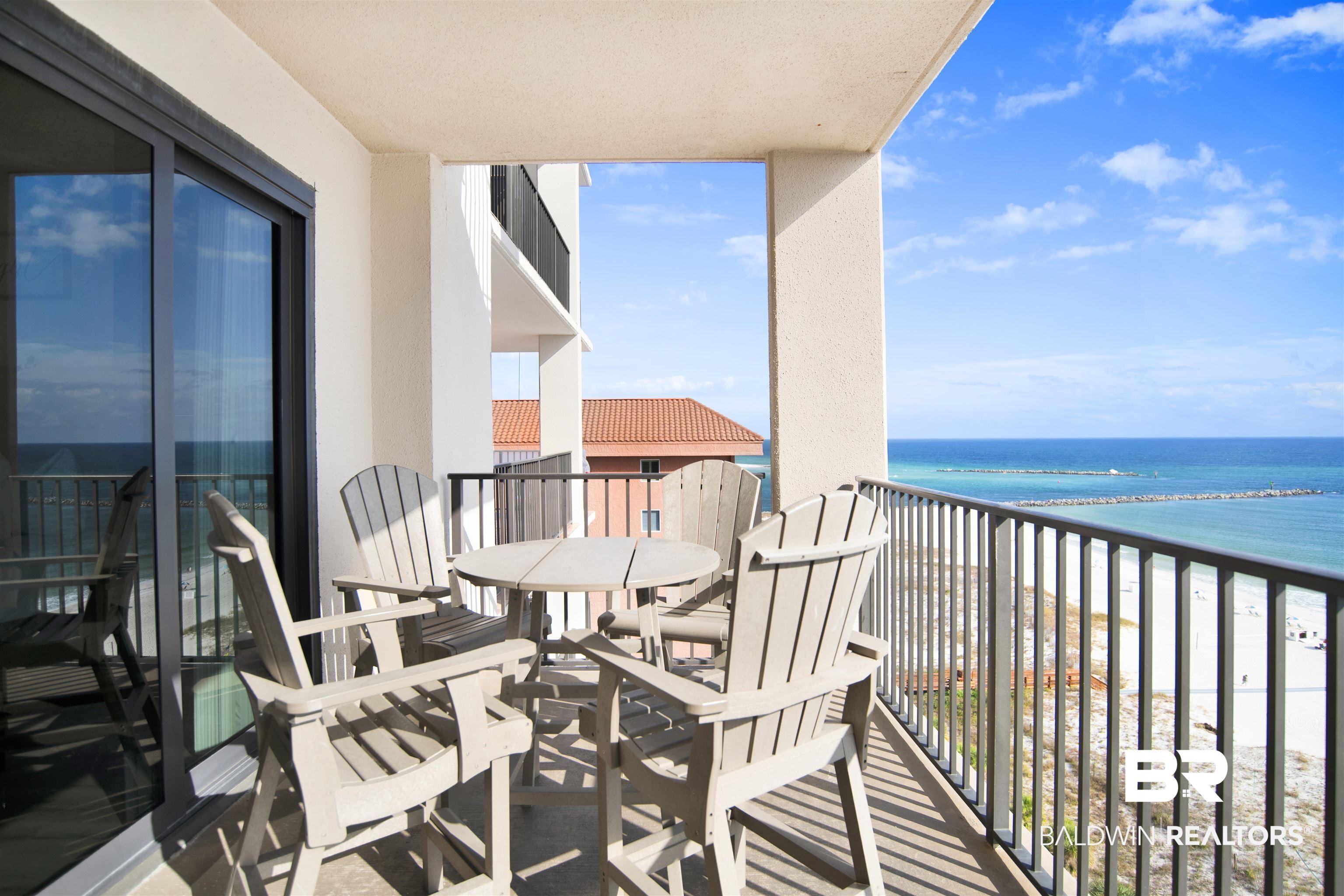 Image 3: Balcony featuring view of water and beach