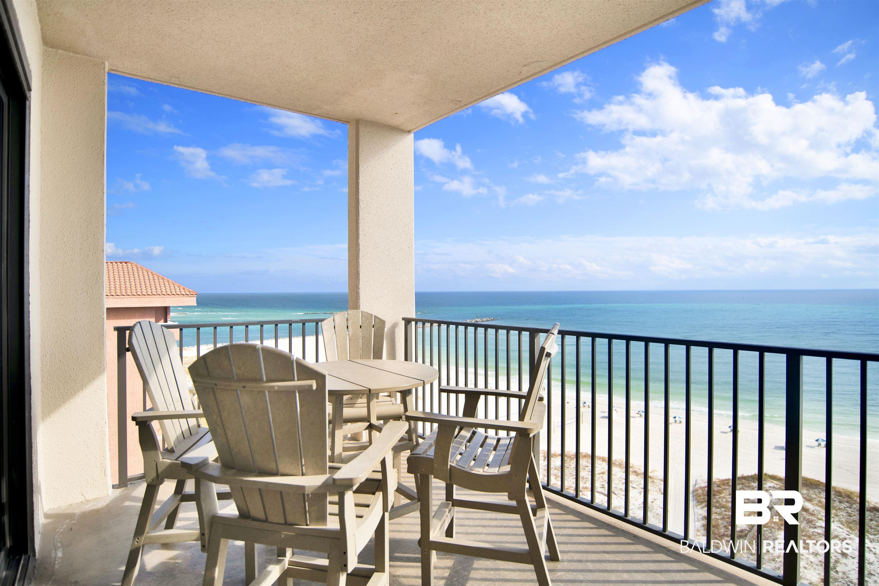 Image 4: Balcony featuring view of water and beach