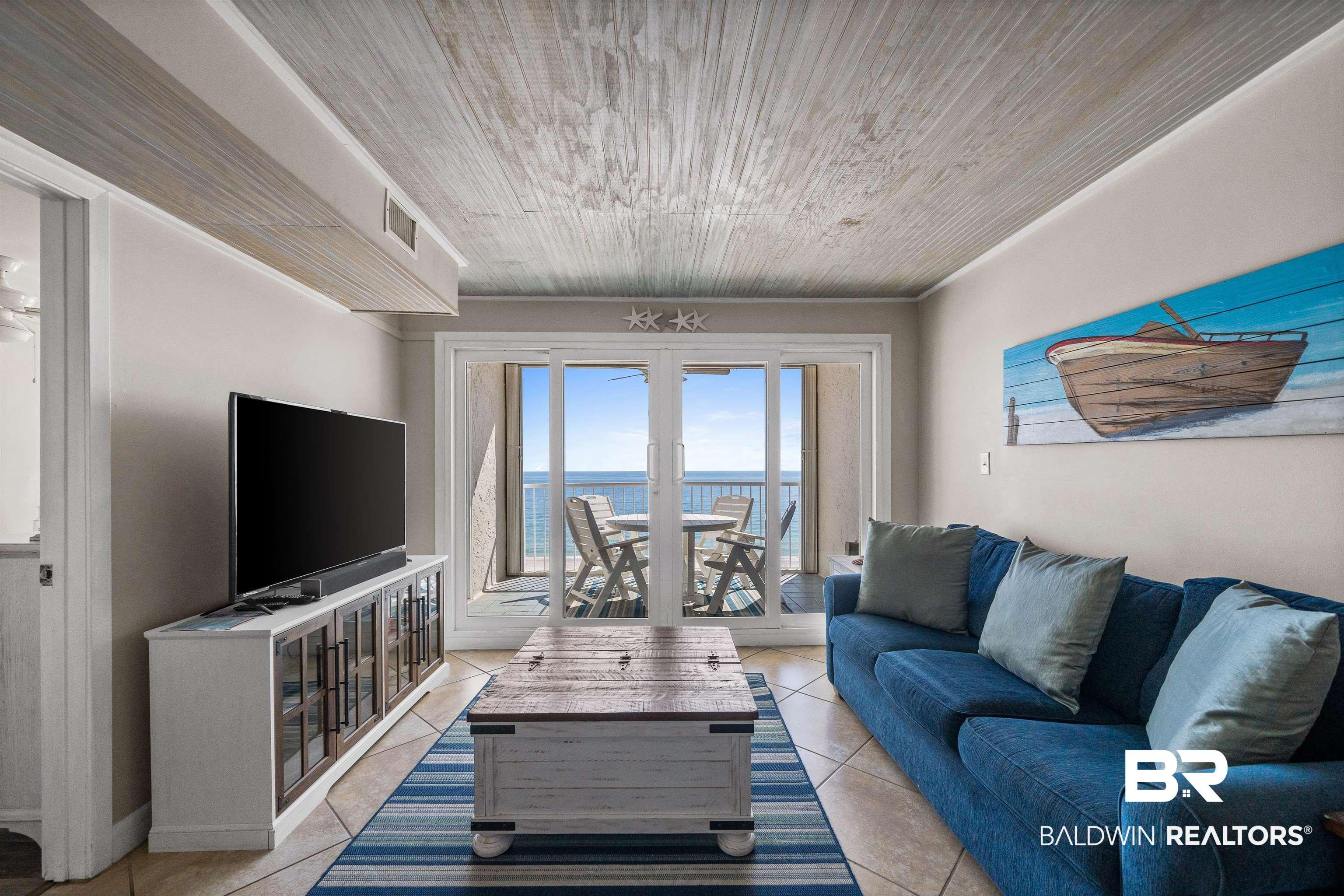Image 4: Living room featuring light tile patterned flooring