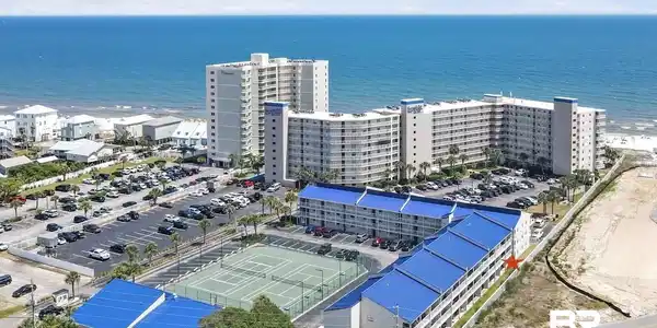 Image 2: Drone / aerial view of apartment complex and a large body of water