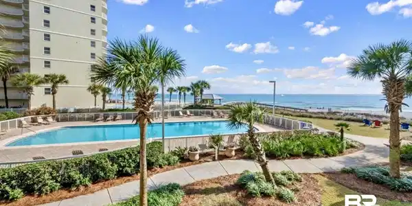 Image 4: Community pool with a water view