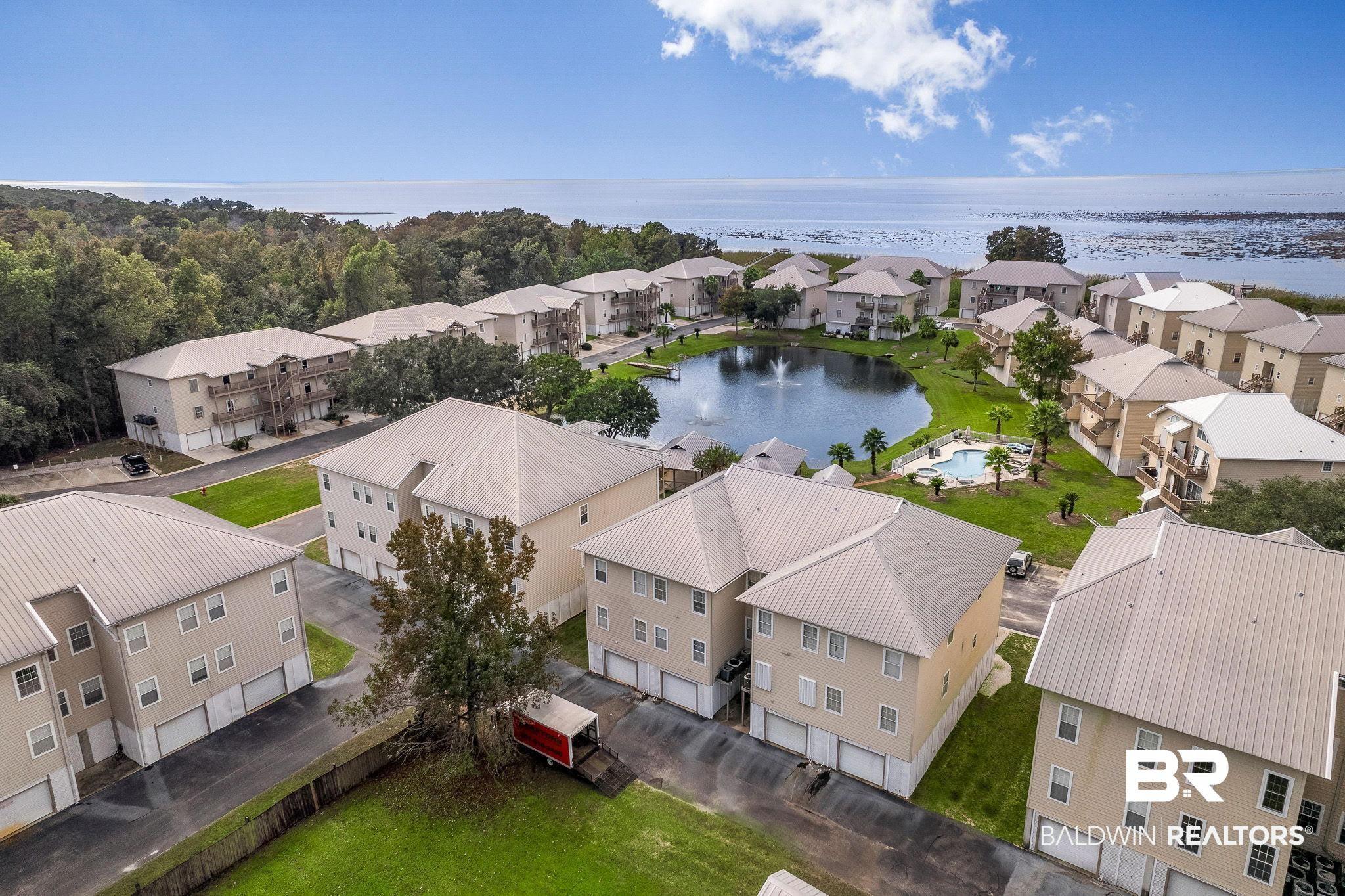 Image 1: Aerial view of residential area with a large body of water