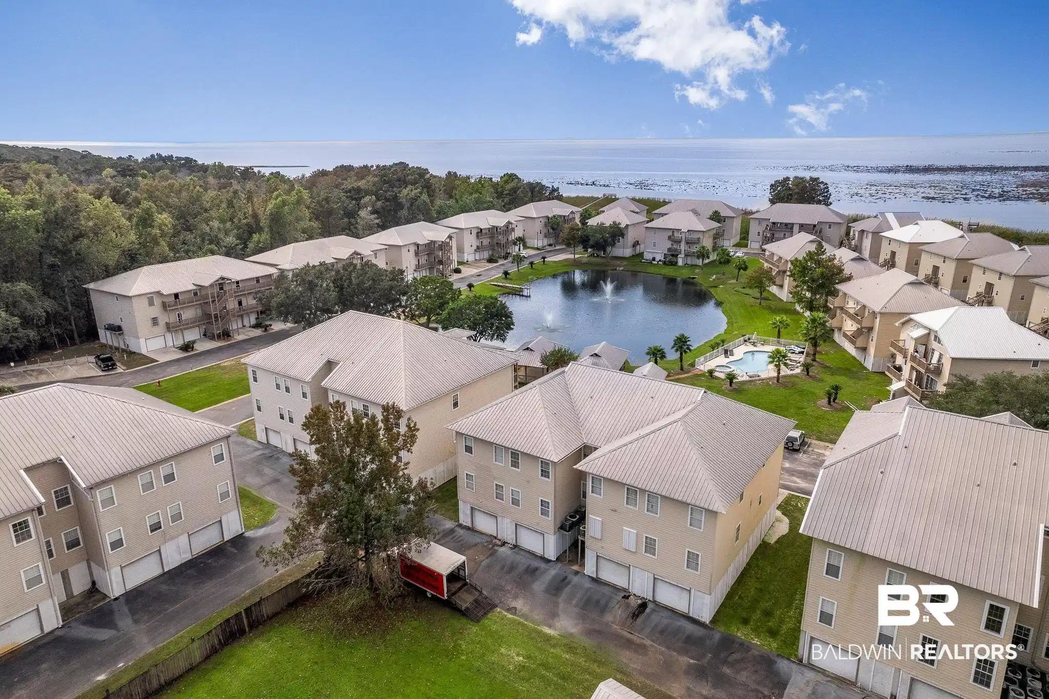 Image 1: Aerial view of residential area with a large body of water