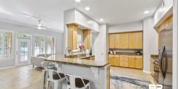 Image 2: Kitchen with a peninsula, a breakfast bar area, appliances with stainless steel finishes, open floor plan, and recessed lighting