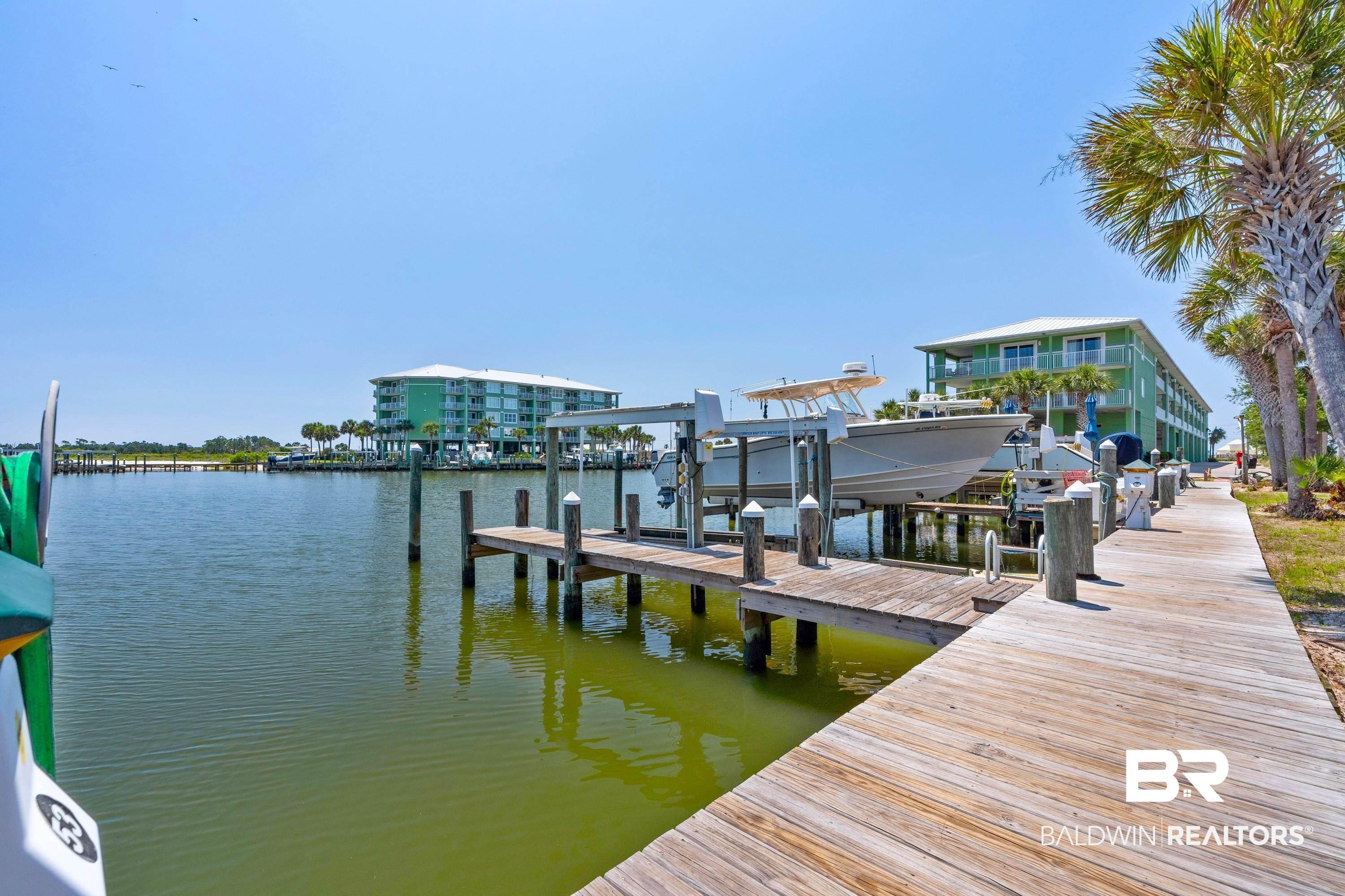 Image 3: Dock area featuring a water view and boat lift