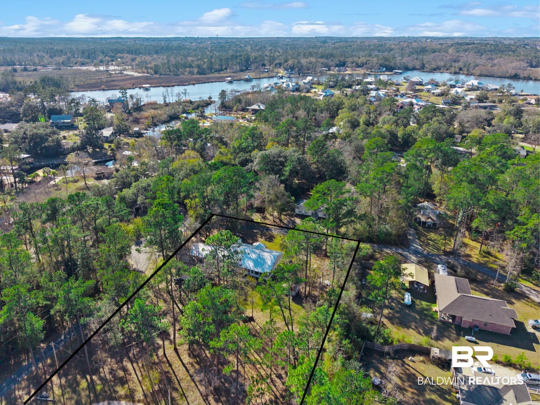 Image 2: Bird's eye view of a nearby body of water and a forest