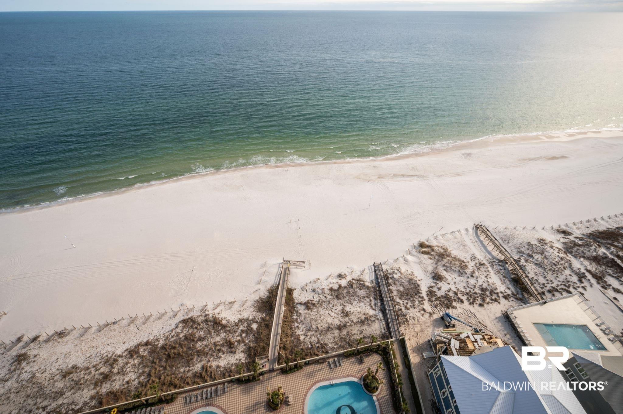 Image 4: Expansive beachfront property featuring white sand and direct ocean access