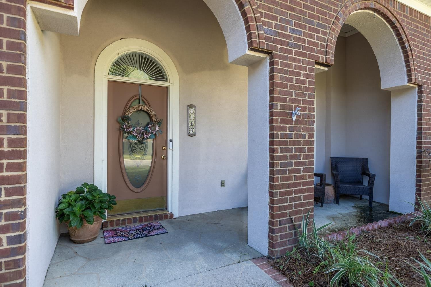 Image 3: Doorway to property with brick siding