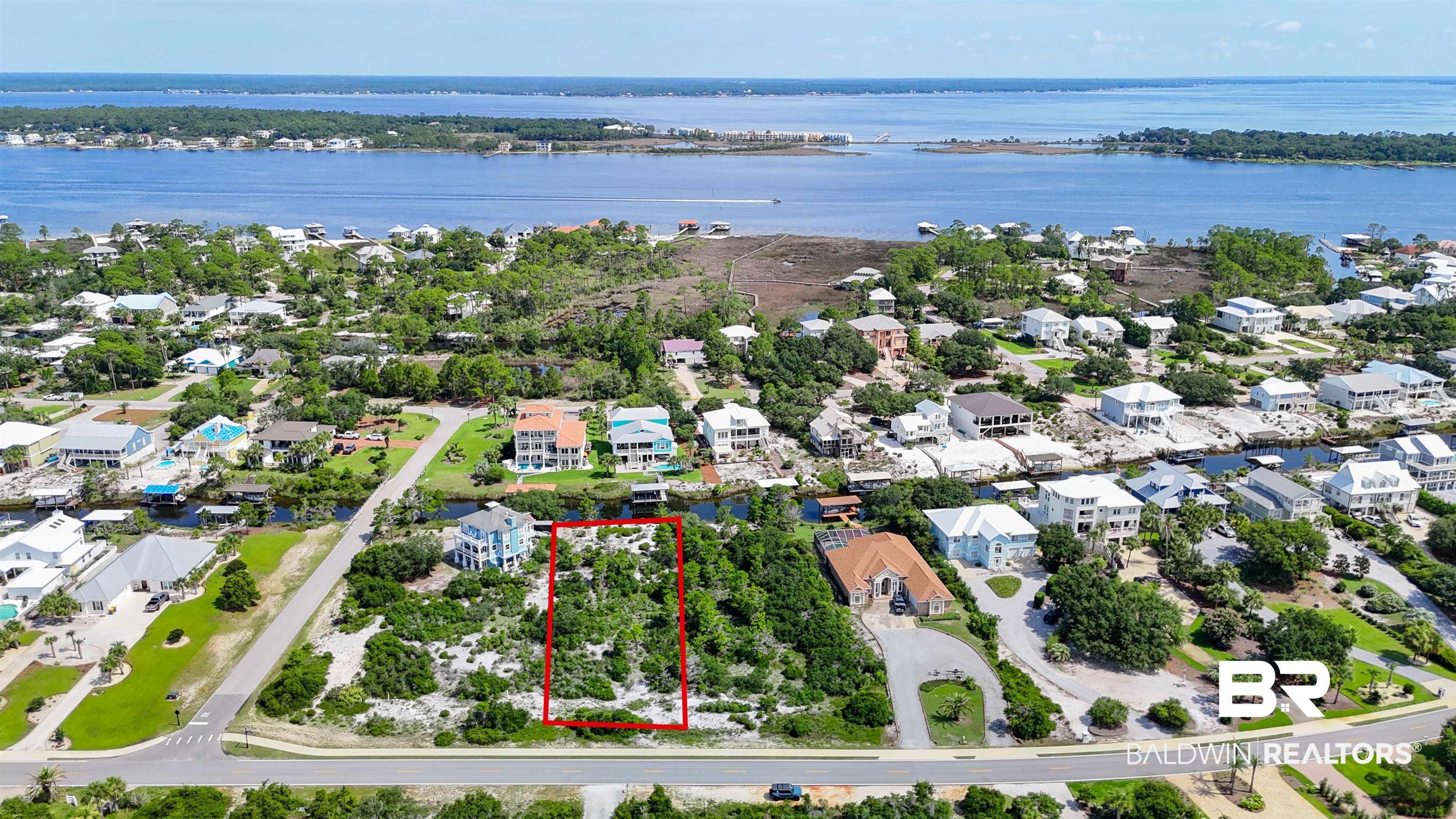 Image 2: Aerial view of property and surrounding area with property parcel outlined, a nearby body of water, and nearby suburban area