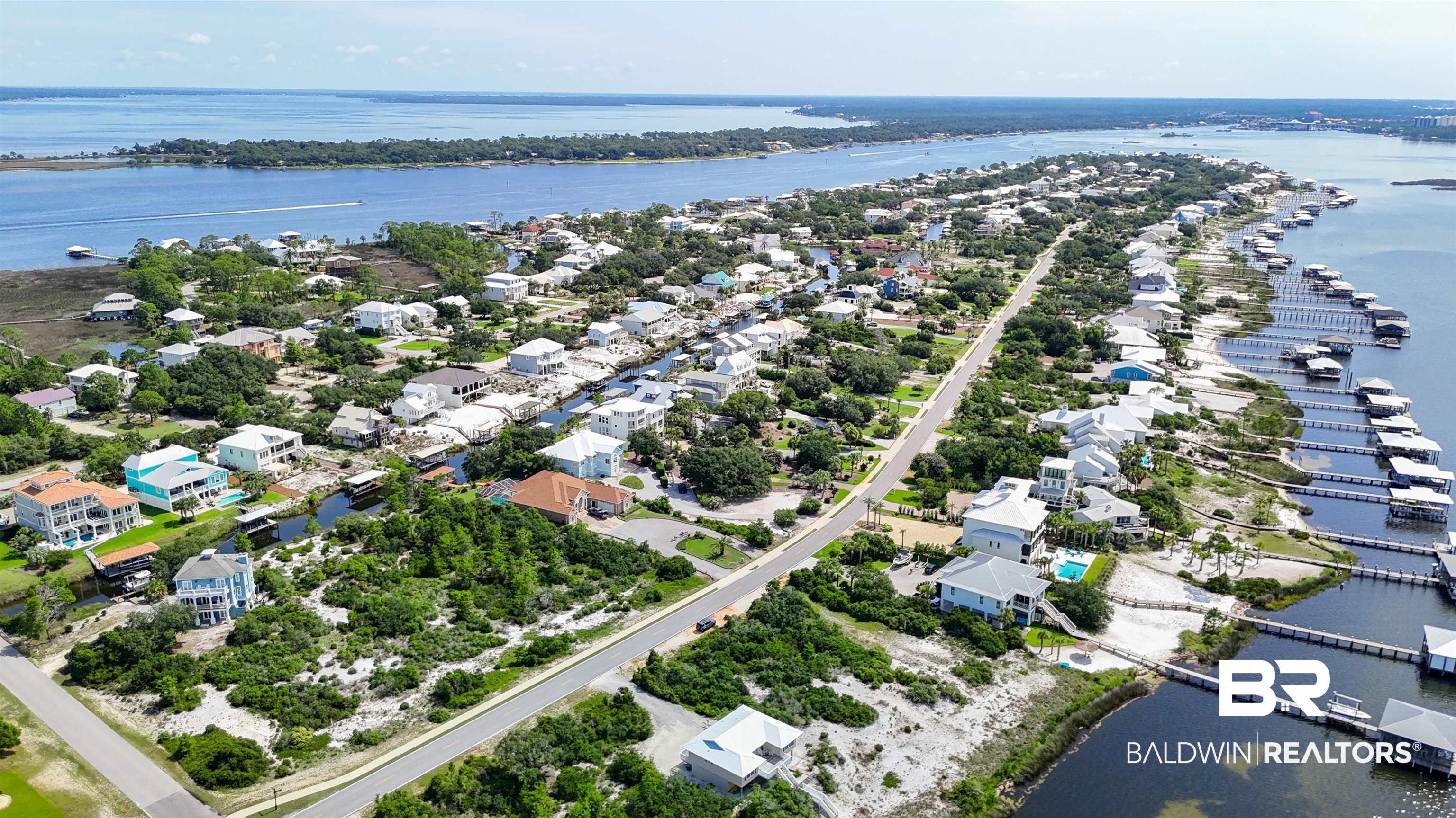 Image 3: Aerial view of residential area featuring a large body of water