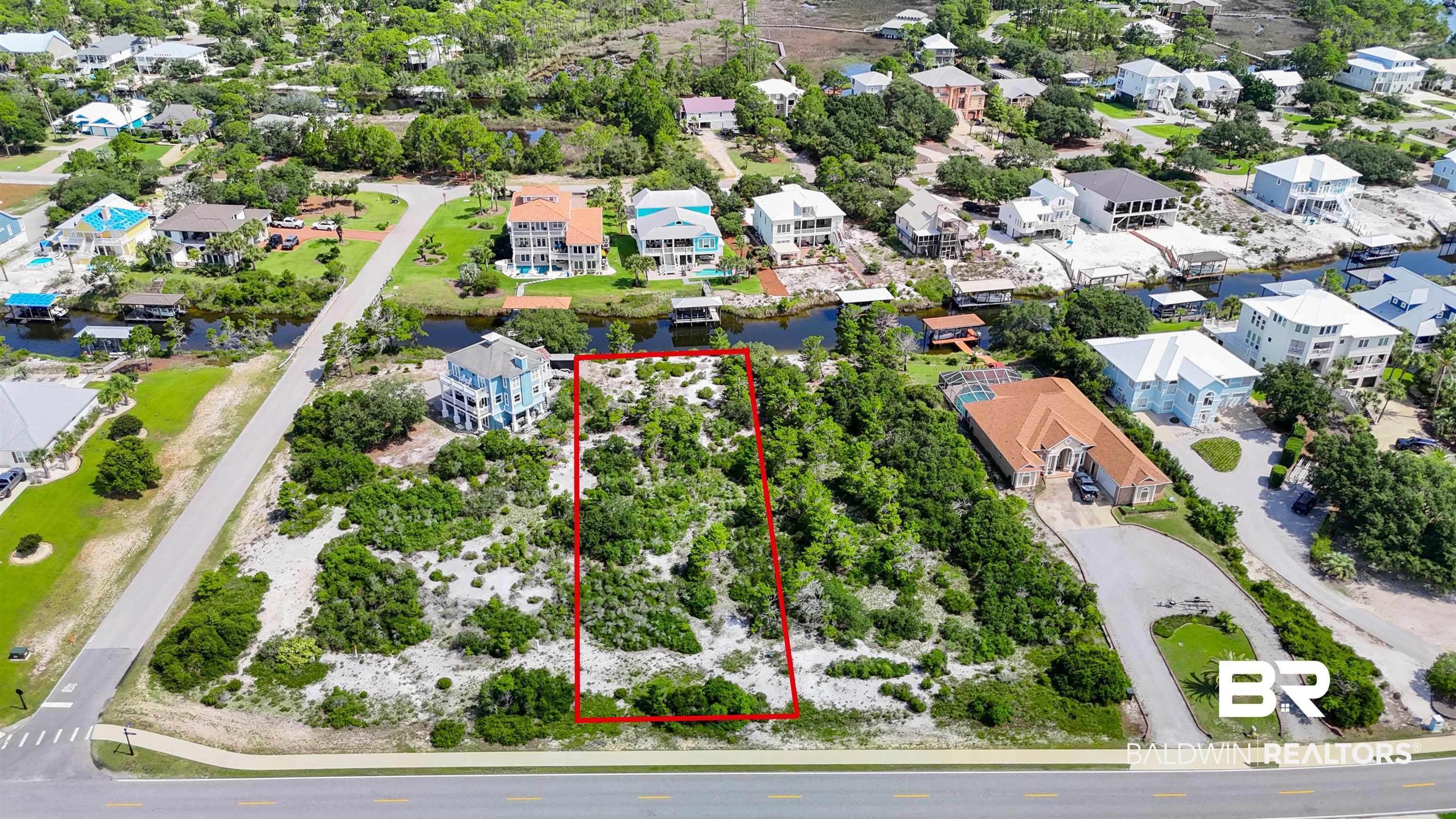Image 4: Aerial view of residential area with property boundaries highlighted and a nearby body of water