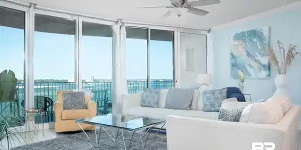 Image 2: Bright living space featuring expansive floor-to-ceiling windows, ceramic tile flooring, and crown molding