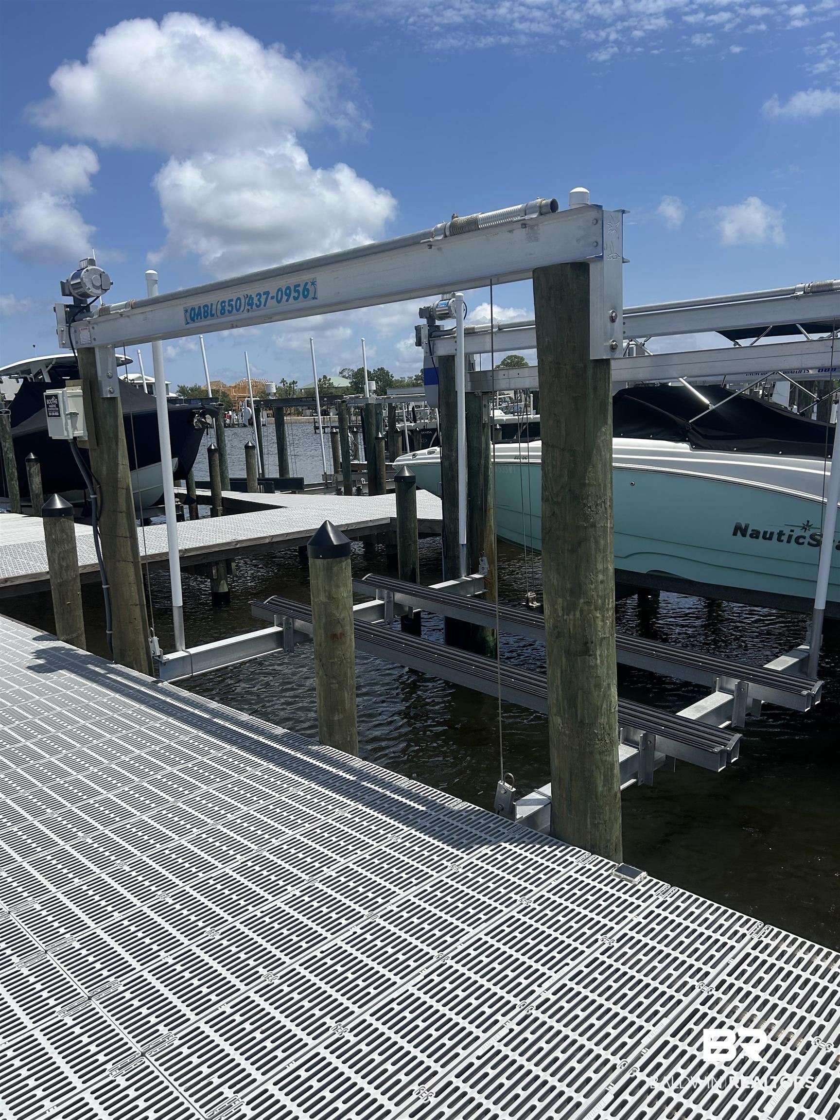 Image 4: Dock featuring boat lift and a water view
