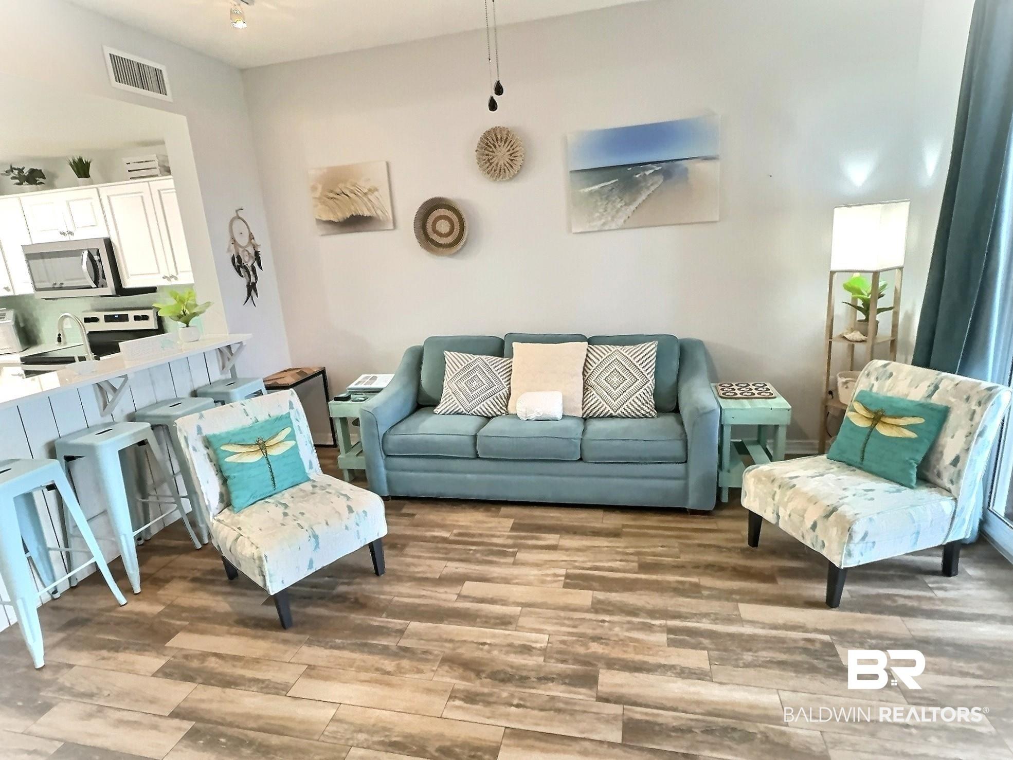 Image 2: Living room featuring light wood-style flooring