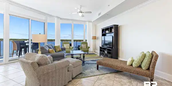 Image 3: Living area with floor to ceiling windows, ceiling fan, light tile patterned floors, and ornamental molding