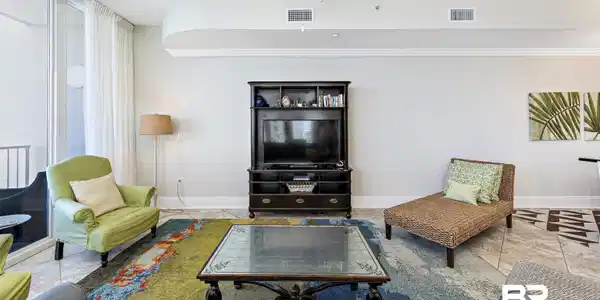 Image 4: Living area with a ceiling fan and tile patterned flooring