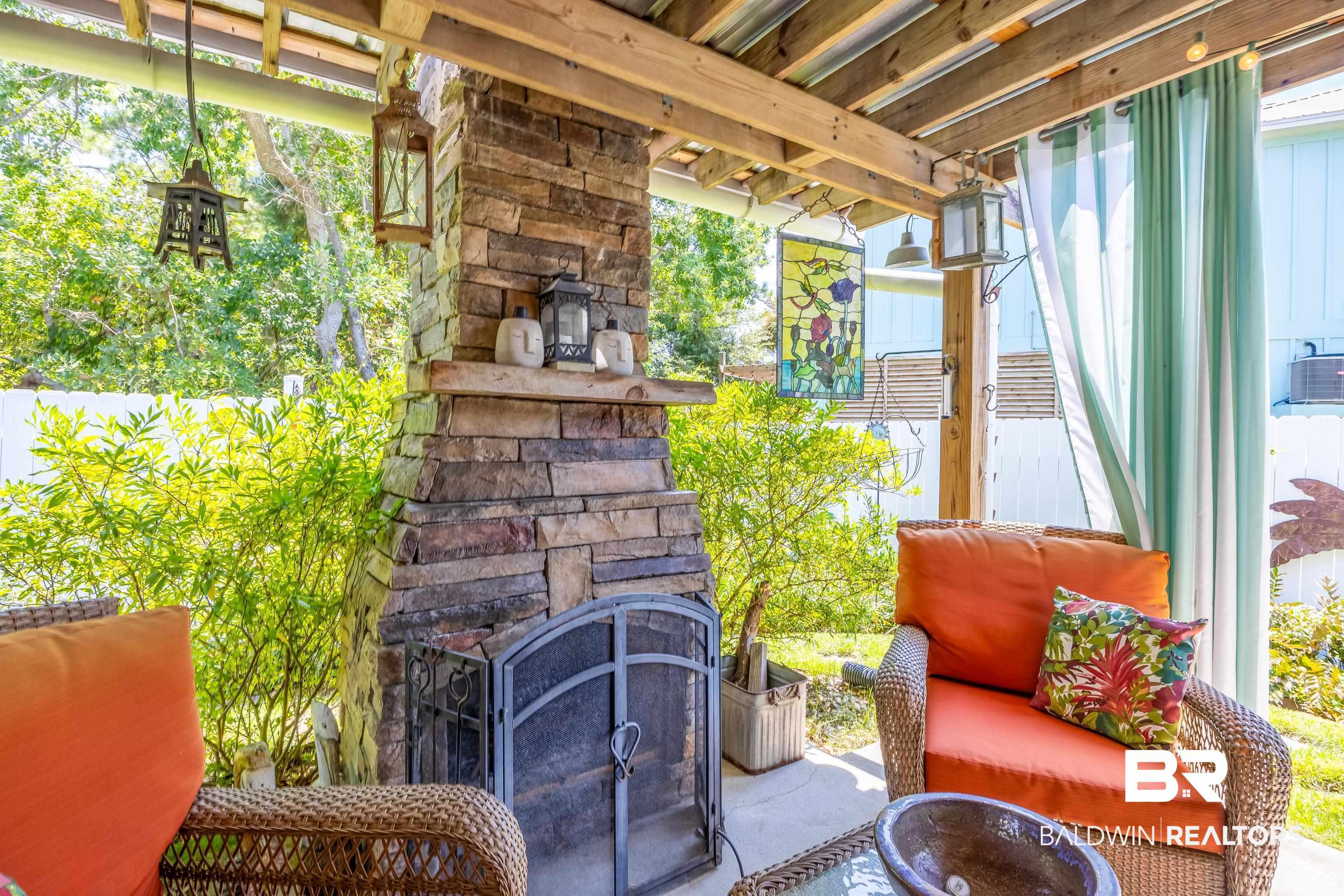 Image 2: View of patio featuring an outdoor stone fireplace