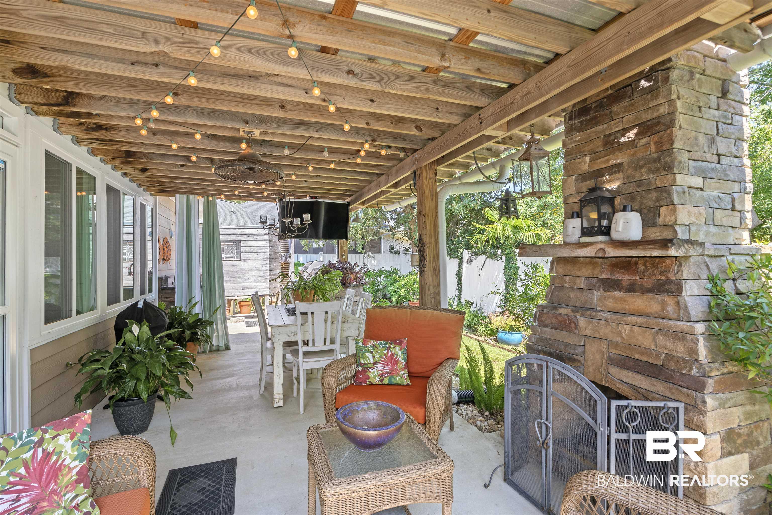 Image 4: View of patio featuring an outdoor living space with a fireplace