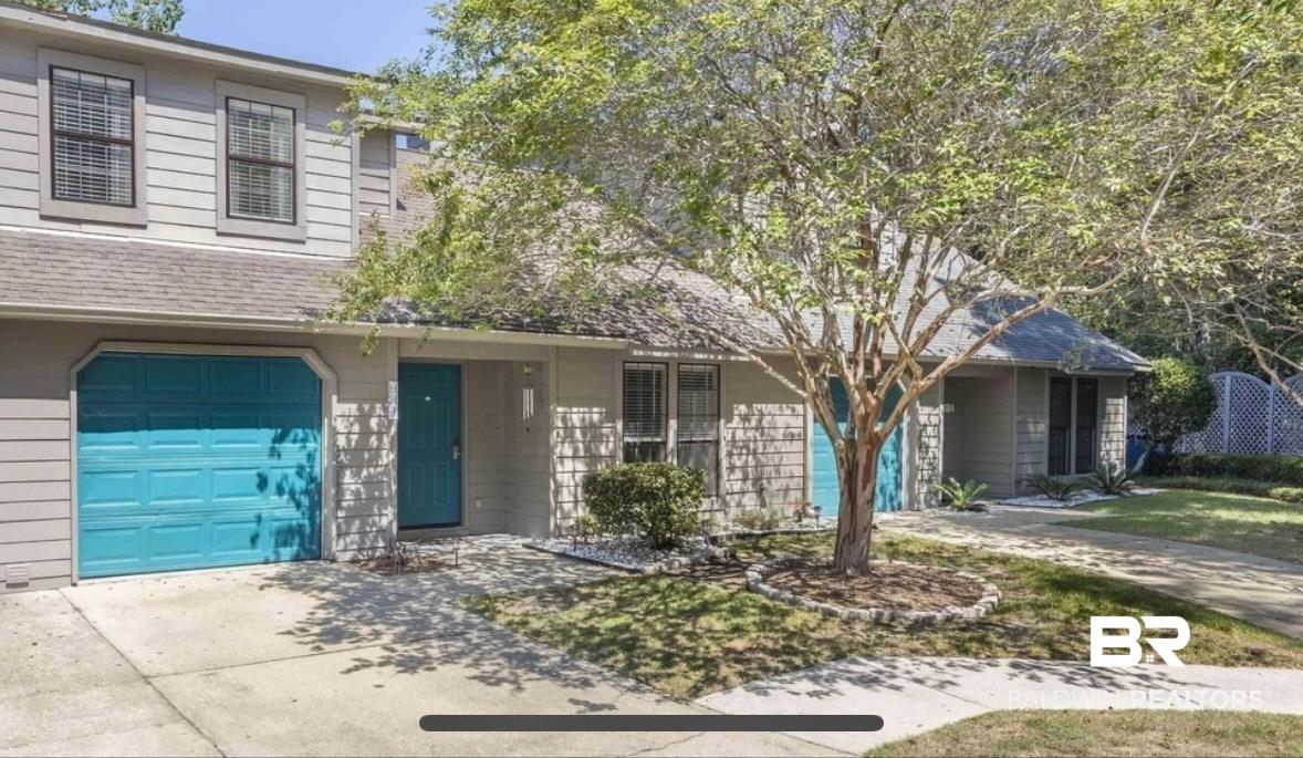 Image 2: View of front of house featuring an attached garage, concrete driveway, and a shingled roof