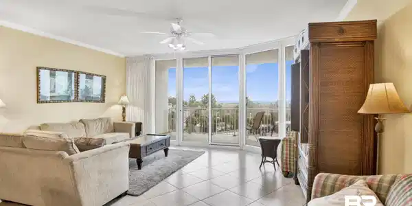 Image 3: Living room featuring expansive windows, crown molding, a ceiling fan, a textured ceiling, and light tile patterned floors