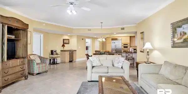 Image 4: Living room featuring ornamental molding, a ceiling fan, a chandelier, and light tile patterned floors