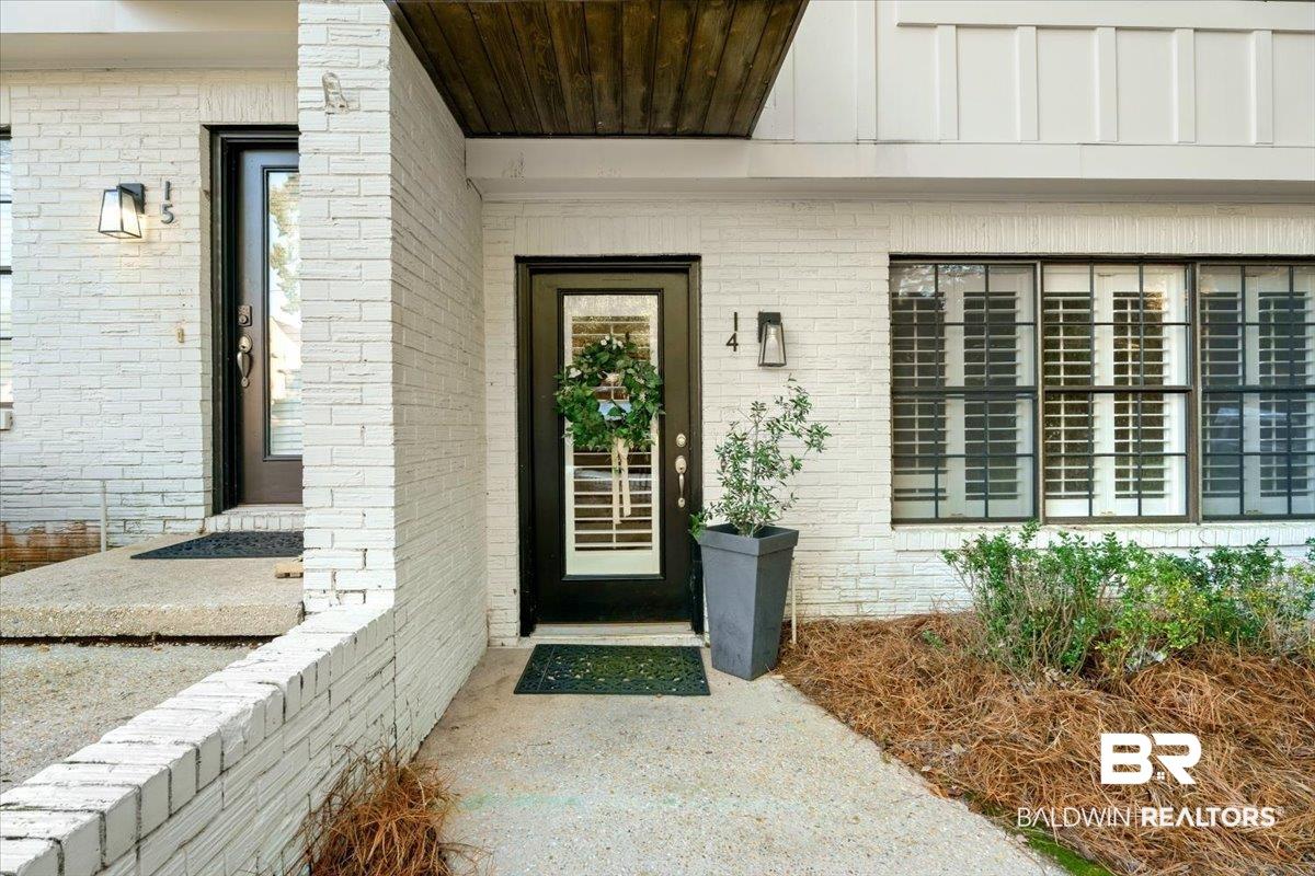 Image 3: View of exterior entry with brick siding and covered porch