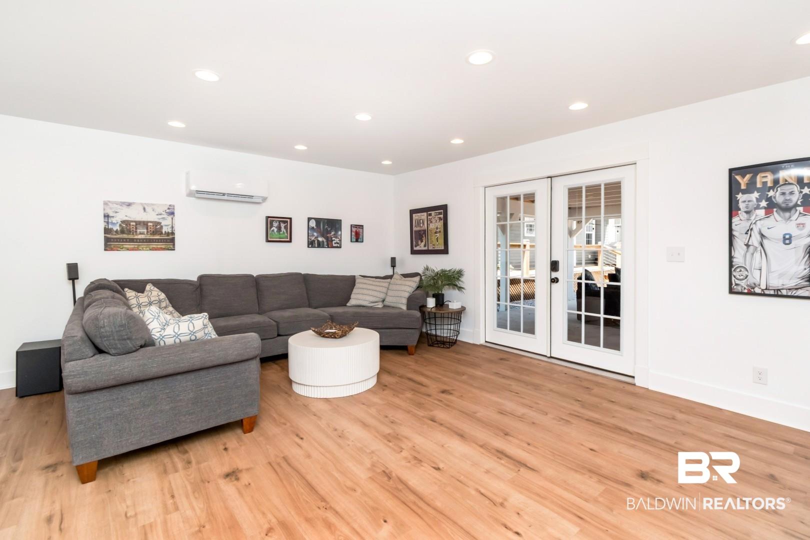 Image 4: Bright interior space featuring wood-finish flooring and recessed lighting
