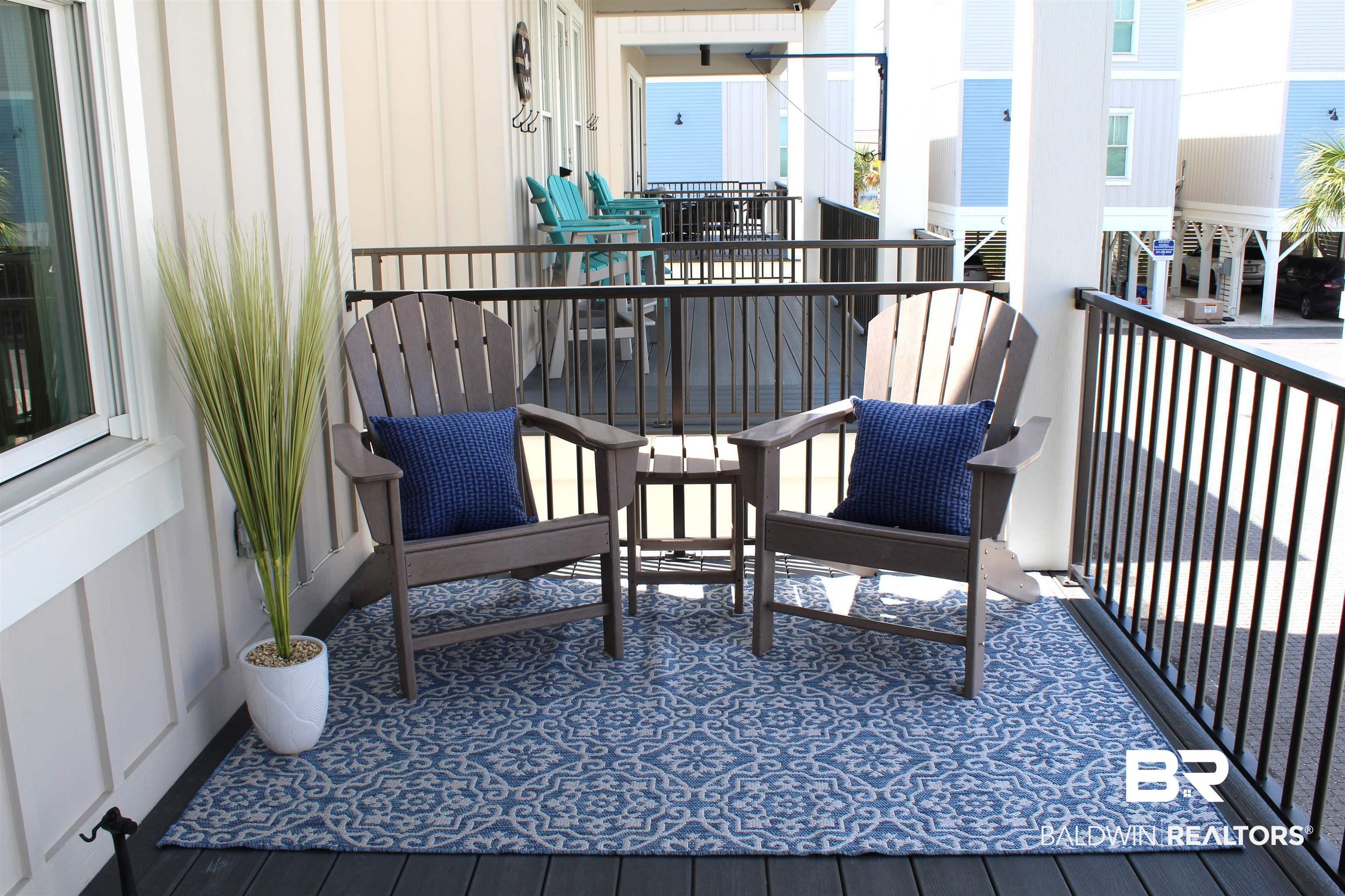 Image 4: Expansive outdoor balcony featuring composite decking and black metal railings