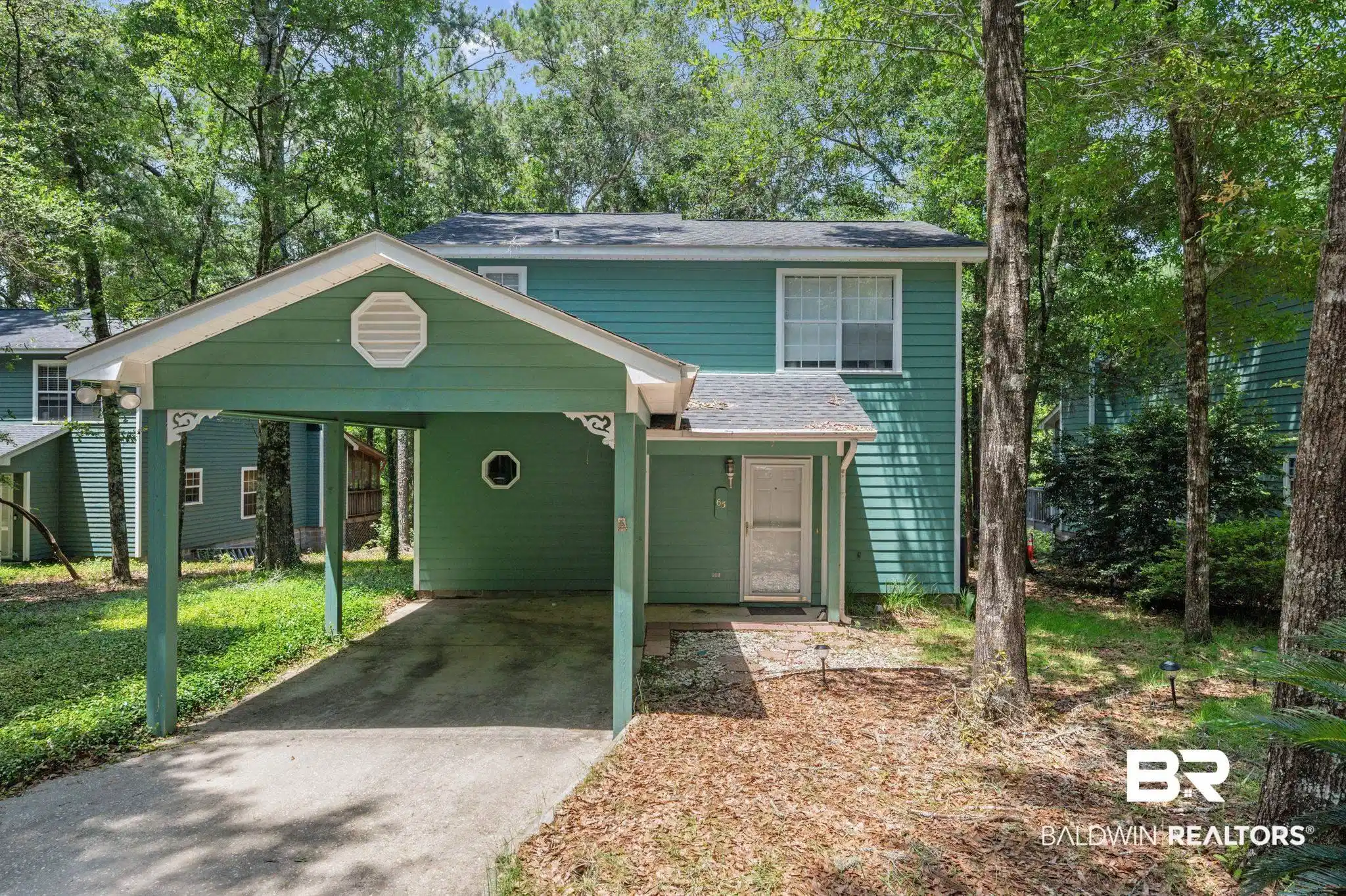 Image 1: Exterior with a carport featuring decorative corbels and a gabled roofline