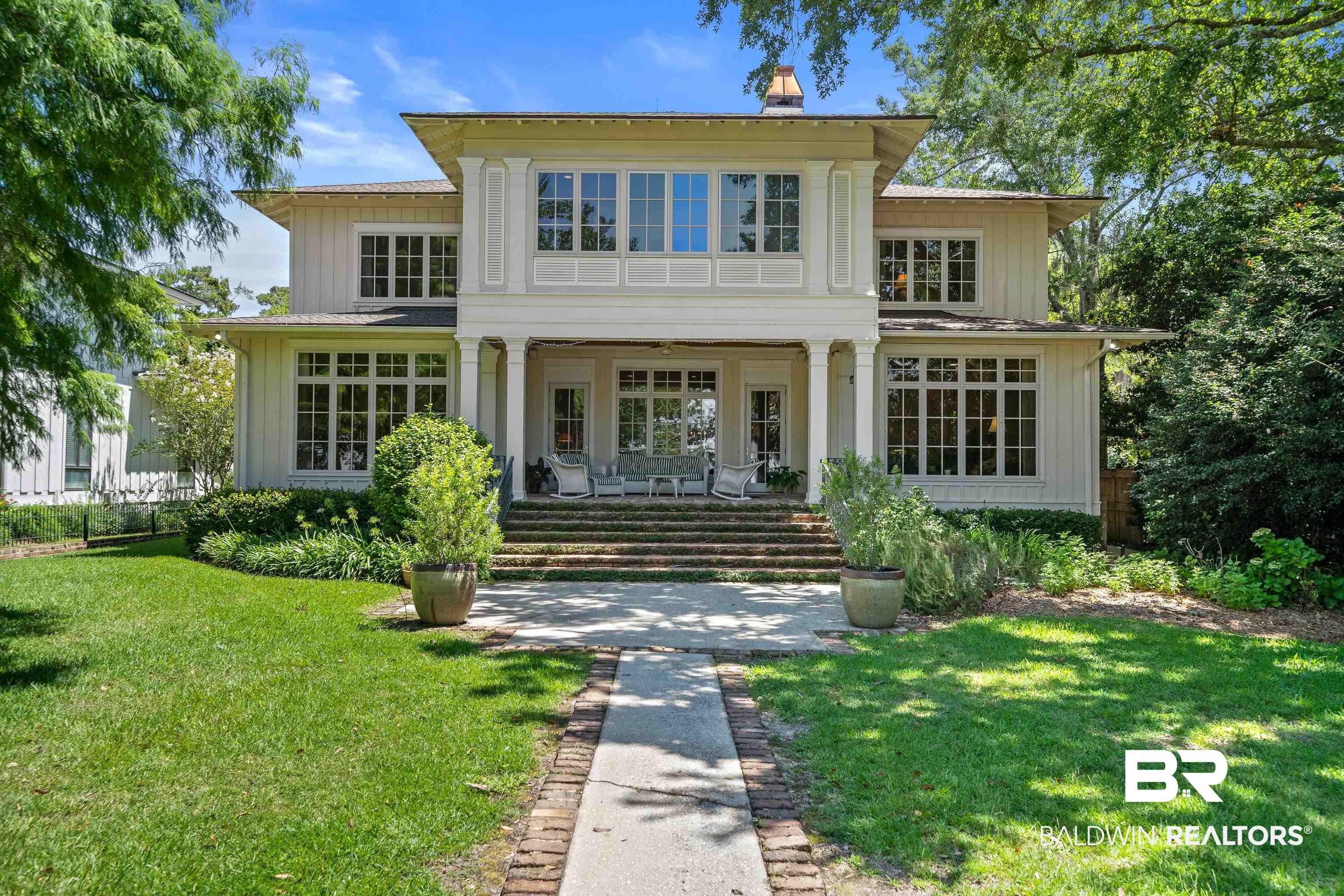 Image 1: View of front of property featuring a front lawn, a porch, and a chimney