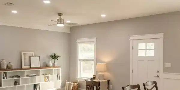 Image 3: Open-concept living area with light-toned wood-finish flooring and custom wood shelves perfect to display your collectables, books or art work