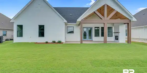 Image 3: Rear view of property with a patio area, a yard, and french doors