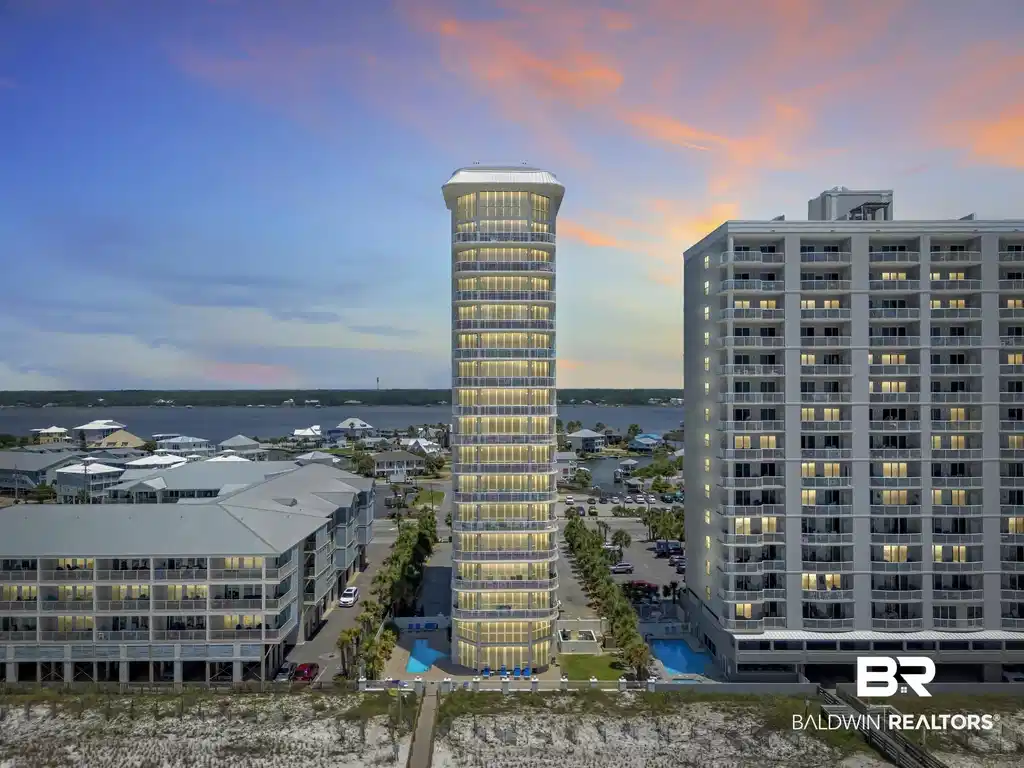 Image 1: Modern high-rise building featuring illuminated balconies and a ground-level swimming pool