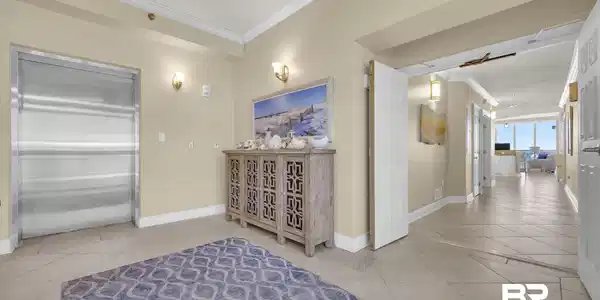 Image 3: Private elevator access to an entryway with tile flooring, crown molding, and recessed lighting