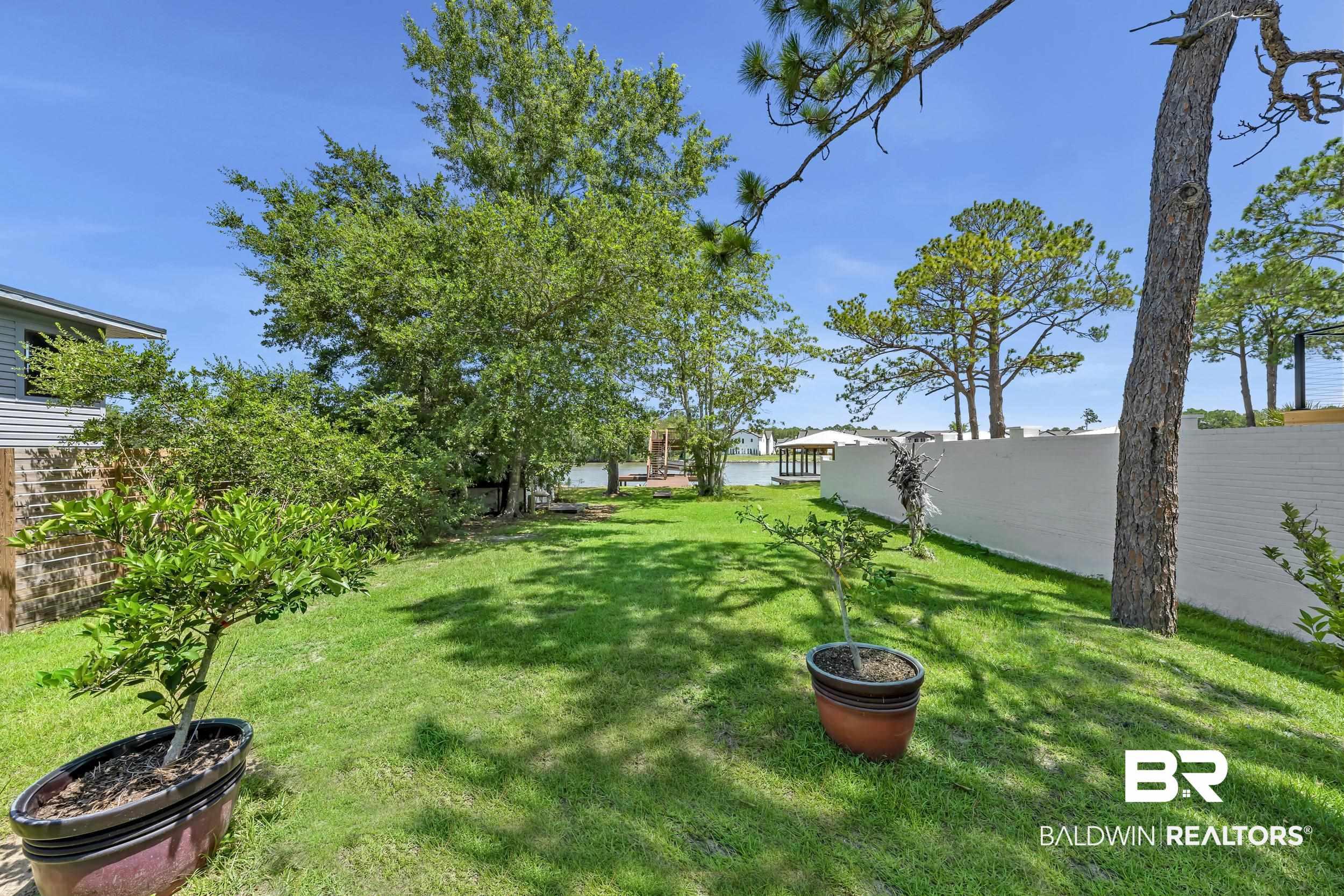 Image 4: Expansive green lawn framed by mature trees