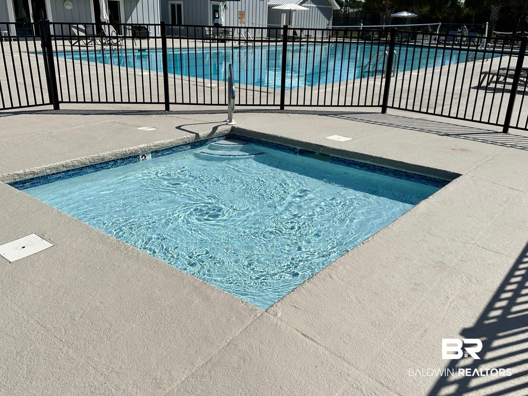 Image 3: Community pool with a patio area