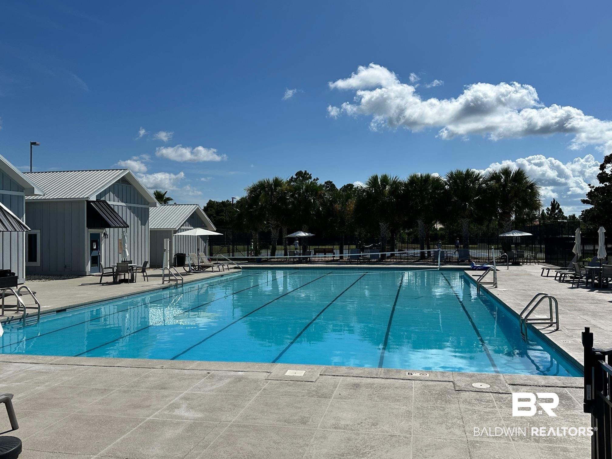 Image 4: Community pool with a patio