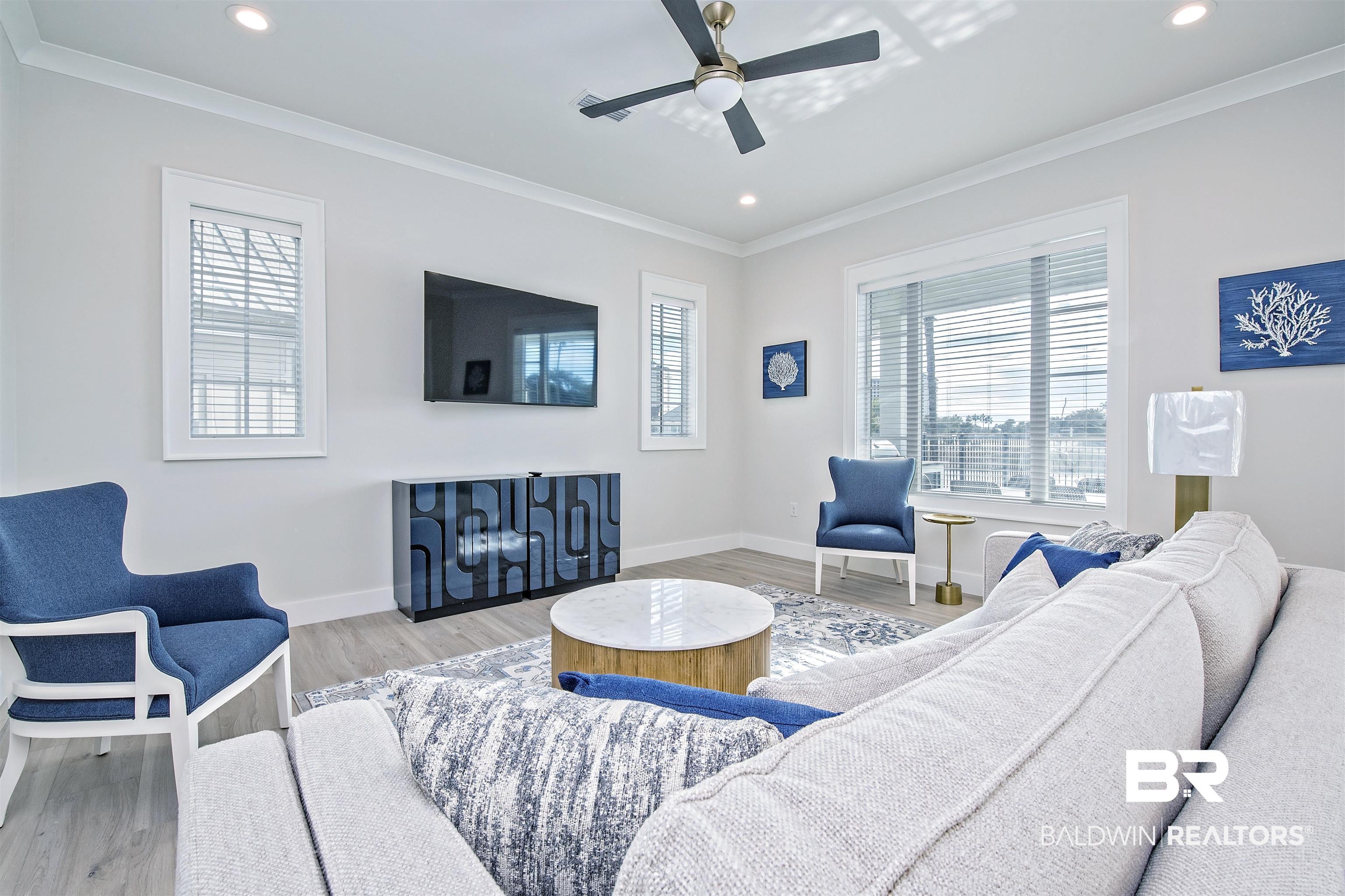 Image 4: Living room featuring ornamental molding, light hardwood / wood-style floors, and ceiling fan