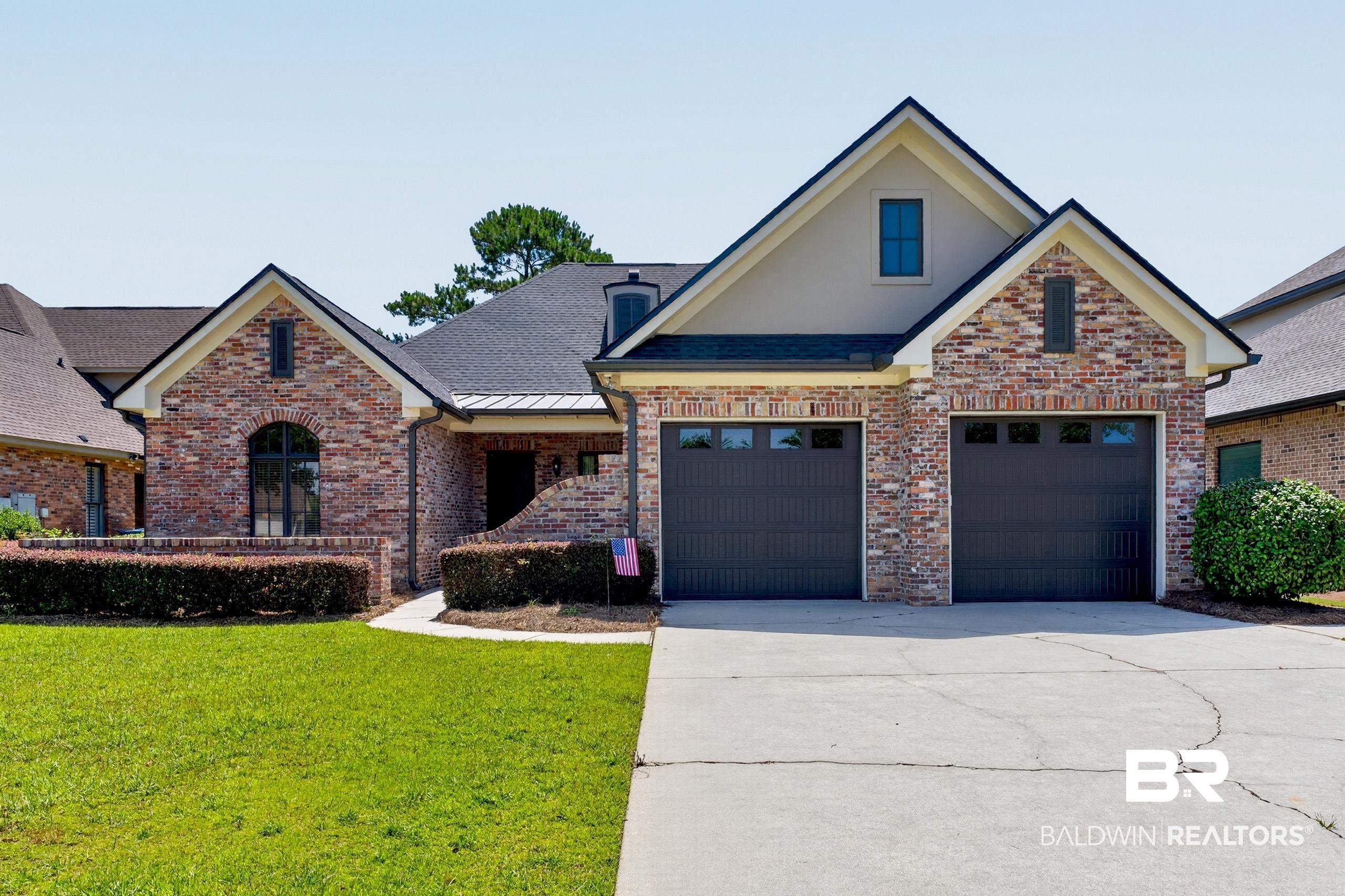 Image 1: Brick facade residence featuring a double-car garage