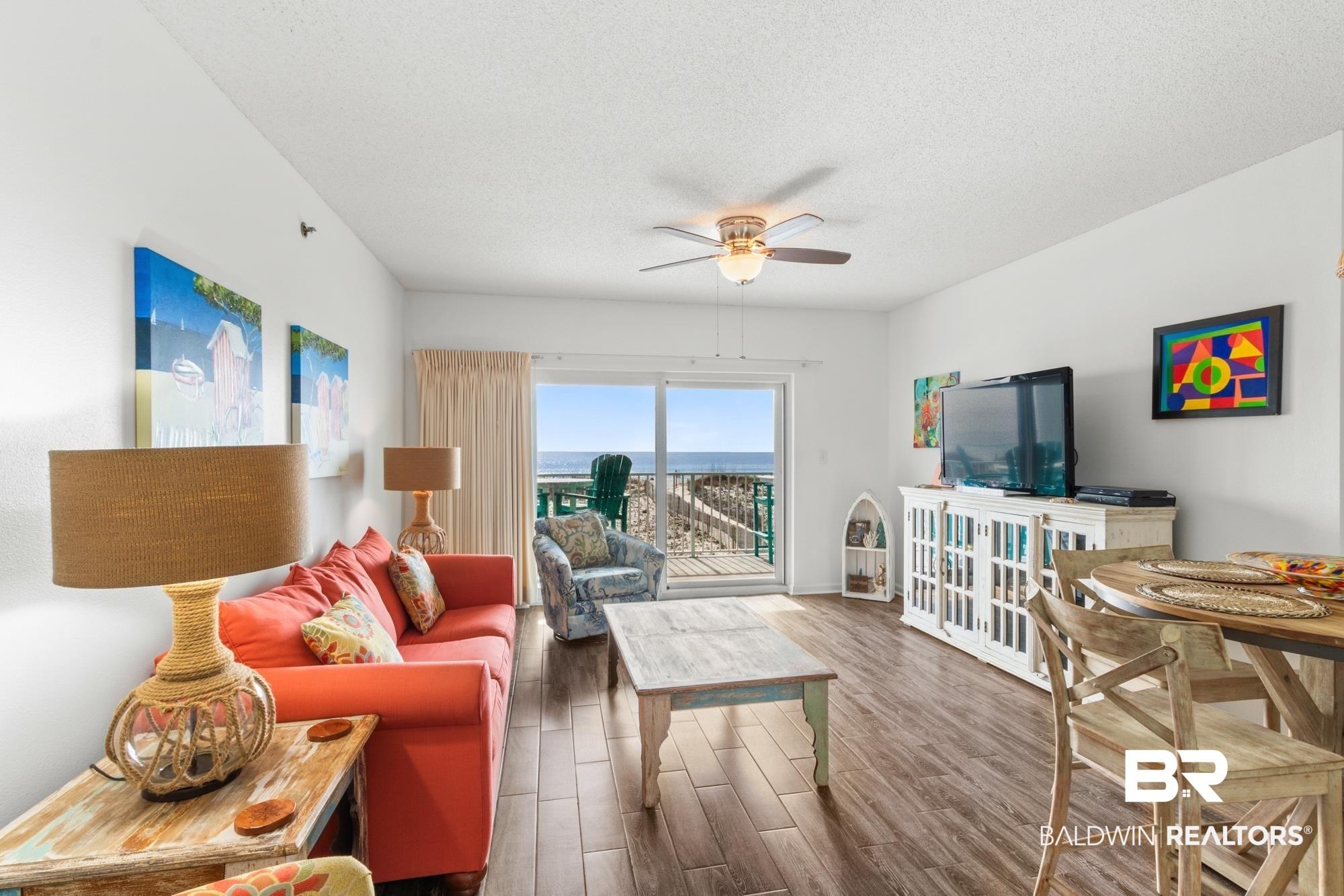 Image 4: Living room with ceiling fan, dark hardwood / wood-style floors, and a textured ceiling