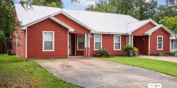Image 4: Red-sided exterior with a white metal roof