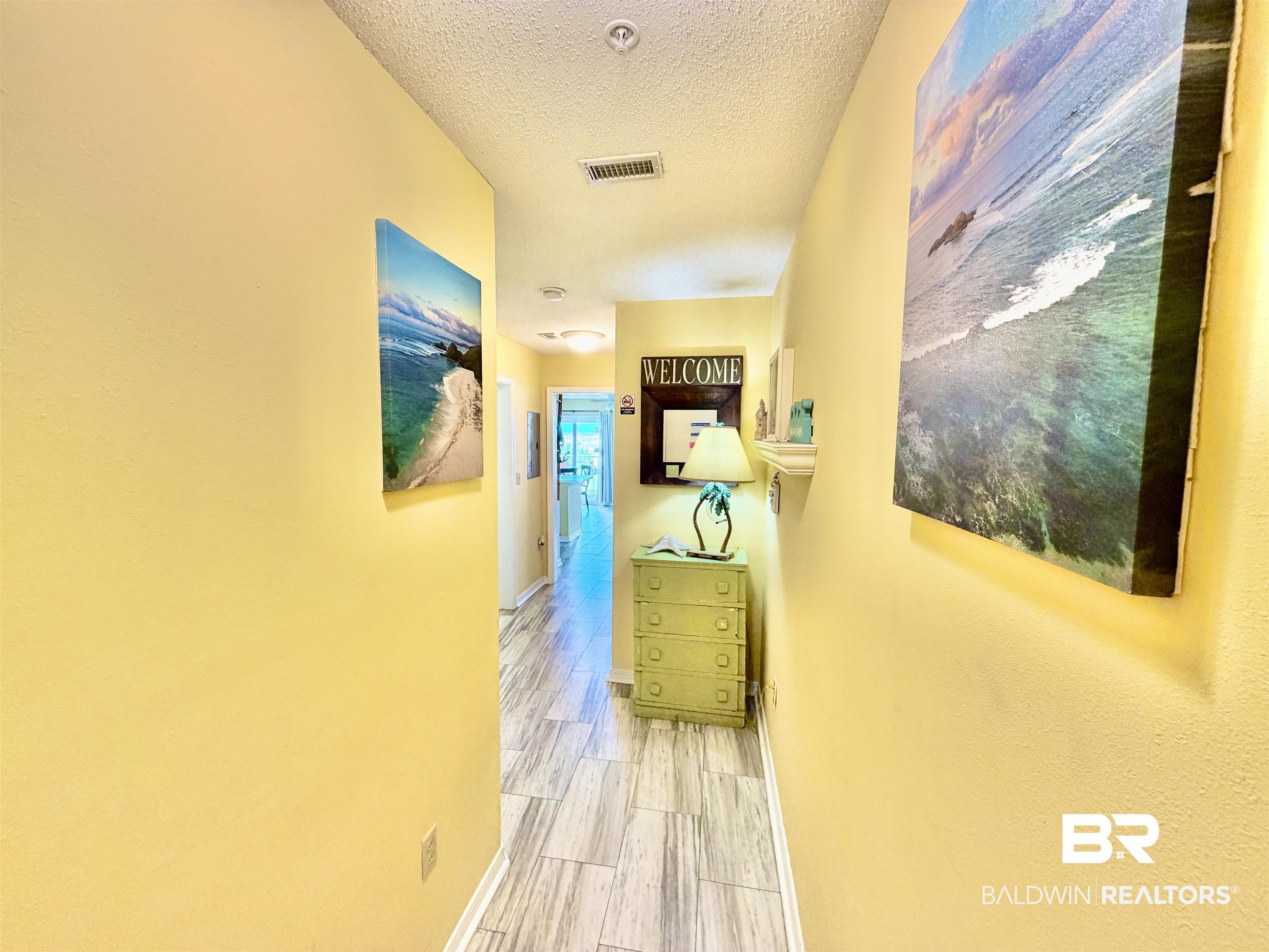 Image 3: Hallway featuring light-toned wood-finish flooring, warm-toned wall finishes, recessed lighting, and white baseboards
